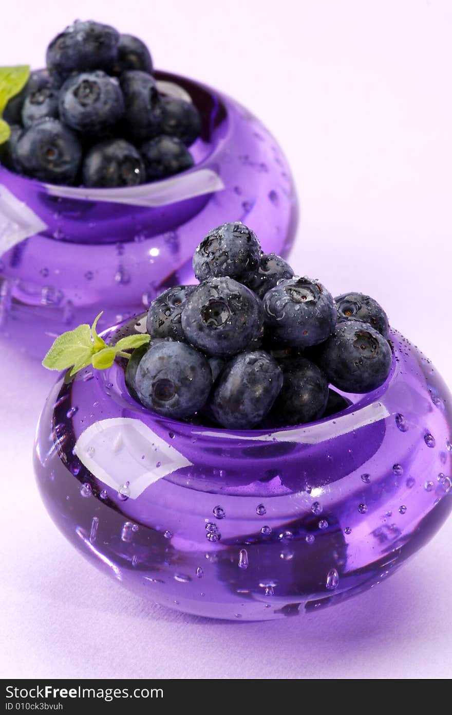 Fresh and sweet bilberries on white background