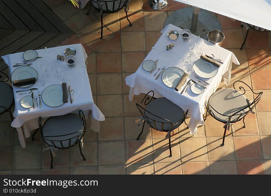 Restaurant table on sunny terrace.