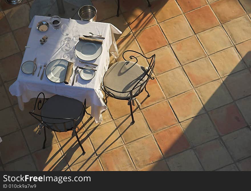 Restaurant table on sunny terrace.