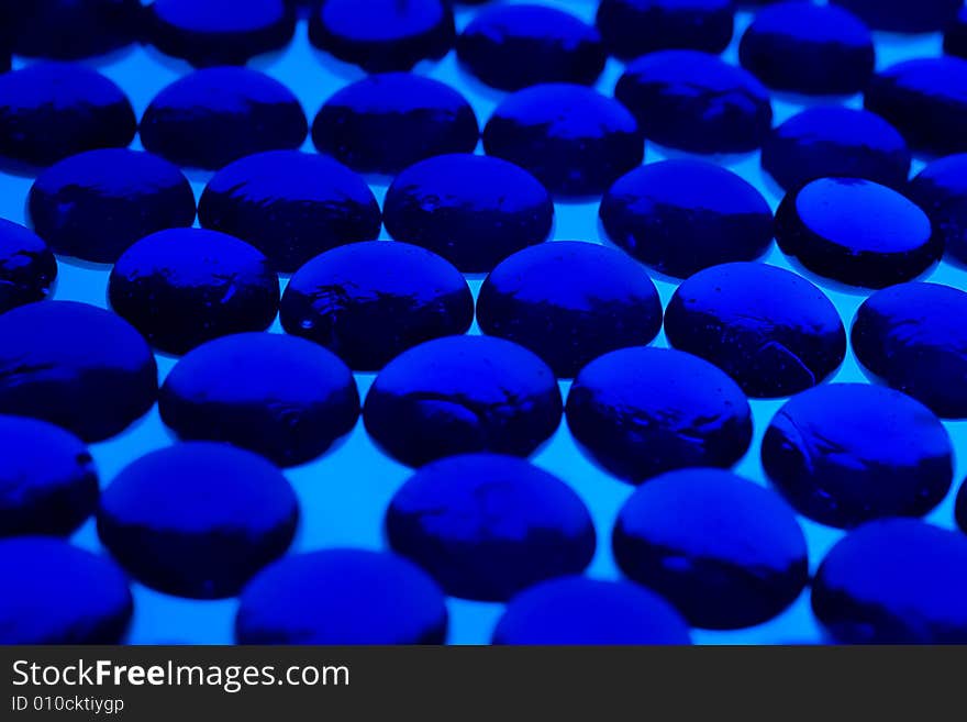 Abstract background made from blue glass pebbles