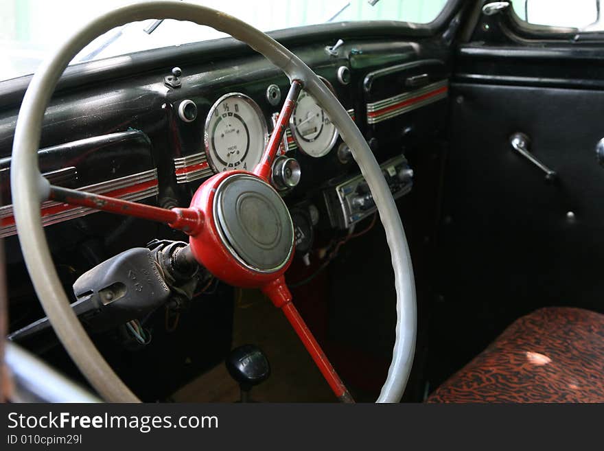 Vintage car interior. Steering wheel and dashboard