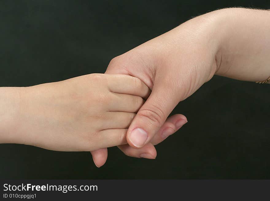 Hand in the hand on the black background. Hand in the hand on the black background