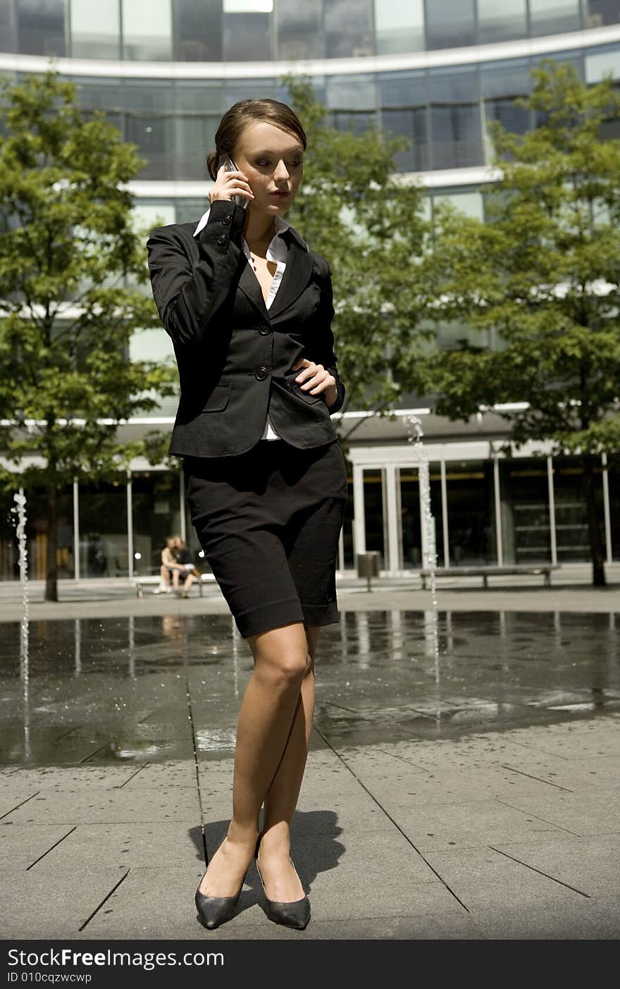 Young and attractive businesswoman talking on the mobile outside. Young and attractive businesswoman talking on the mobile outside