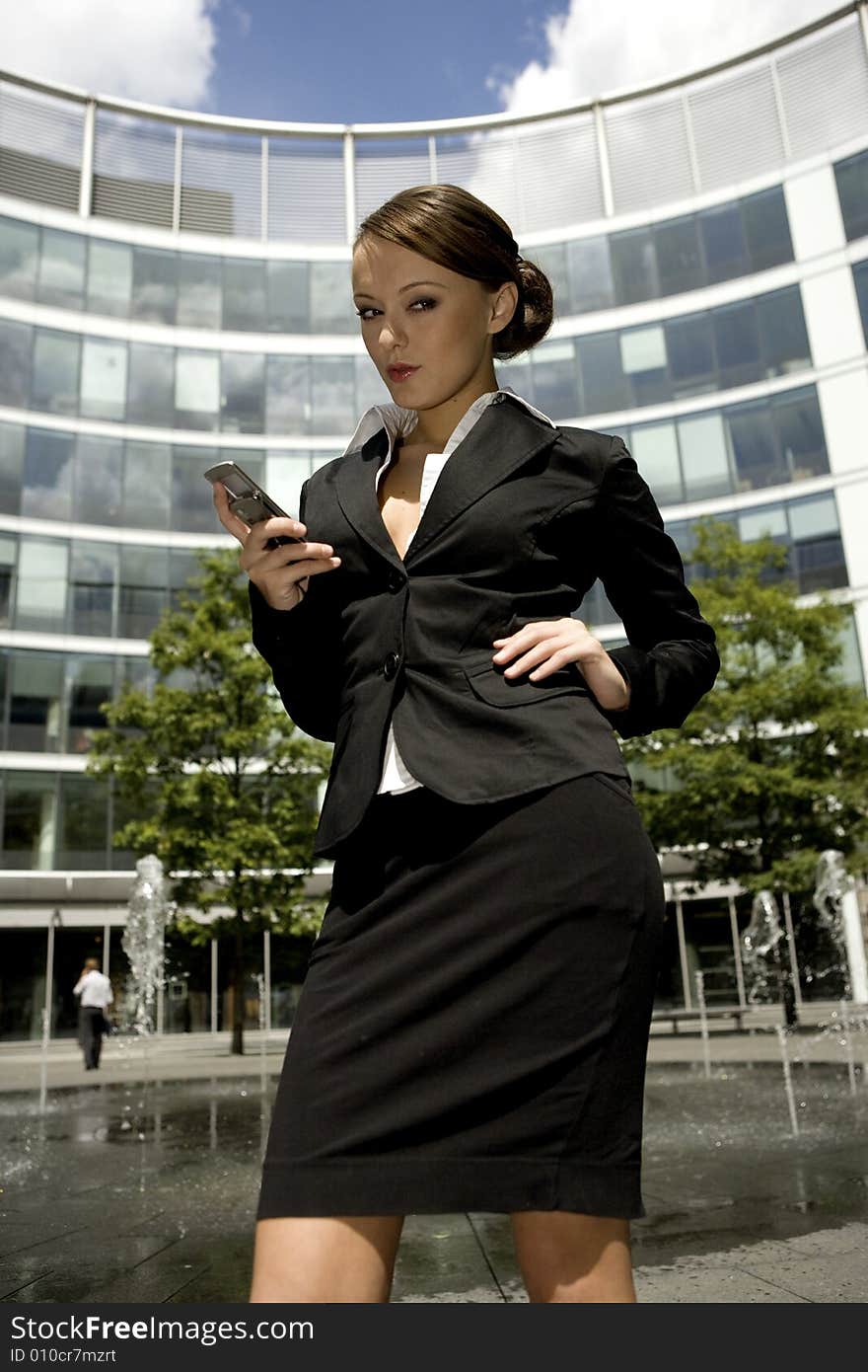 Young and attractive businesswoman talking on the mobile outside. Young and attractive businesswoman talking on the mobile outside