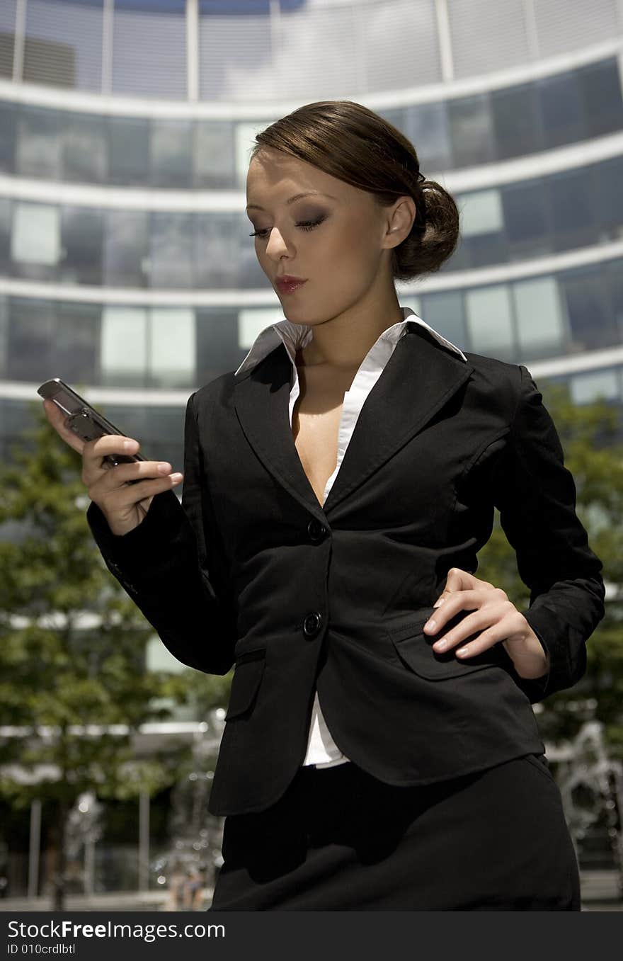 Young and attractive businesswoman talking on the mobile outside. Young and attractive businesswoman talking on the mobile outside