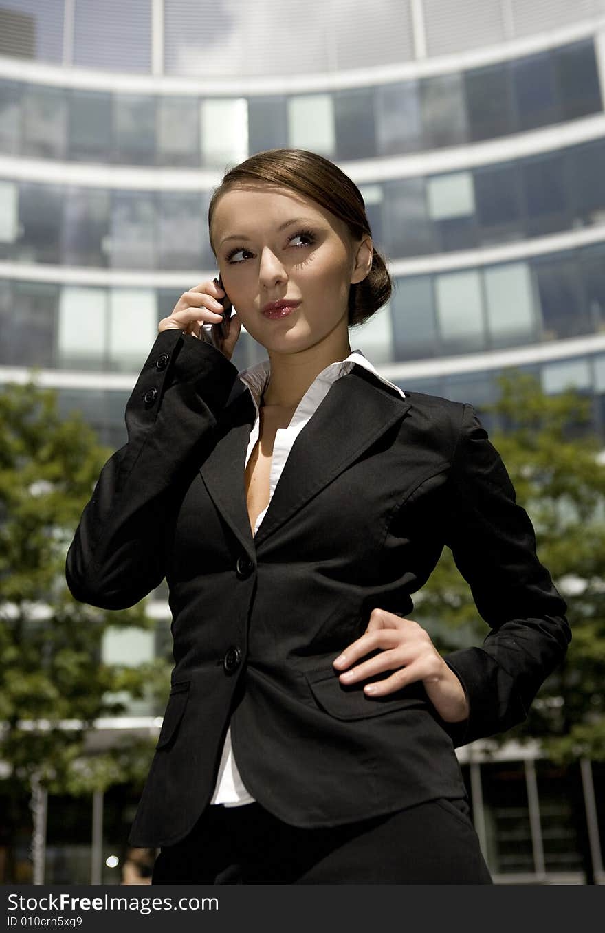 Young and attractive businesswoman talking on the mobile outside. Young and attractive businesswoman talking on the mobile outside