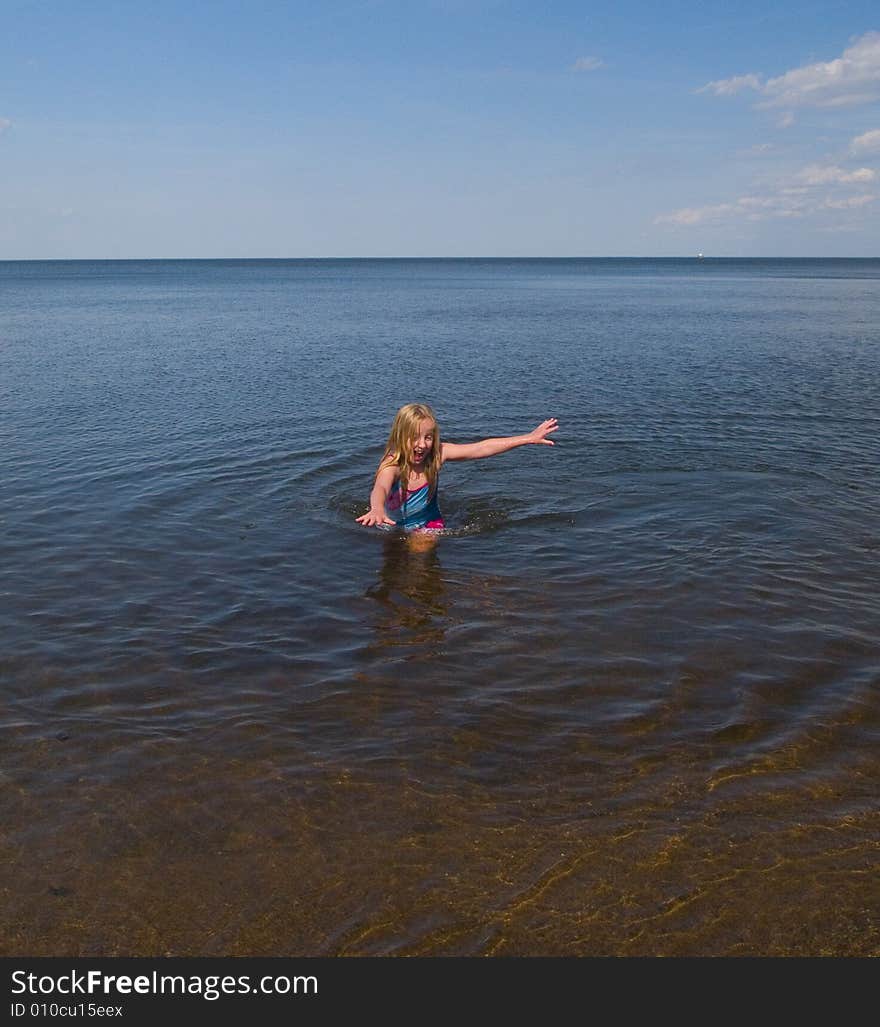 A girl racing to get out of the freezing water of Lake Superior. A girl racing to get out of the freezing water of Lake Superior