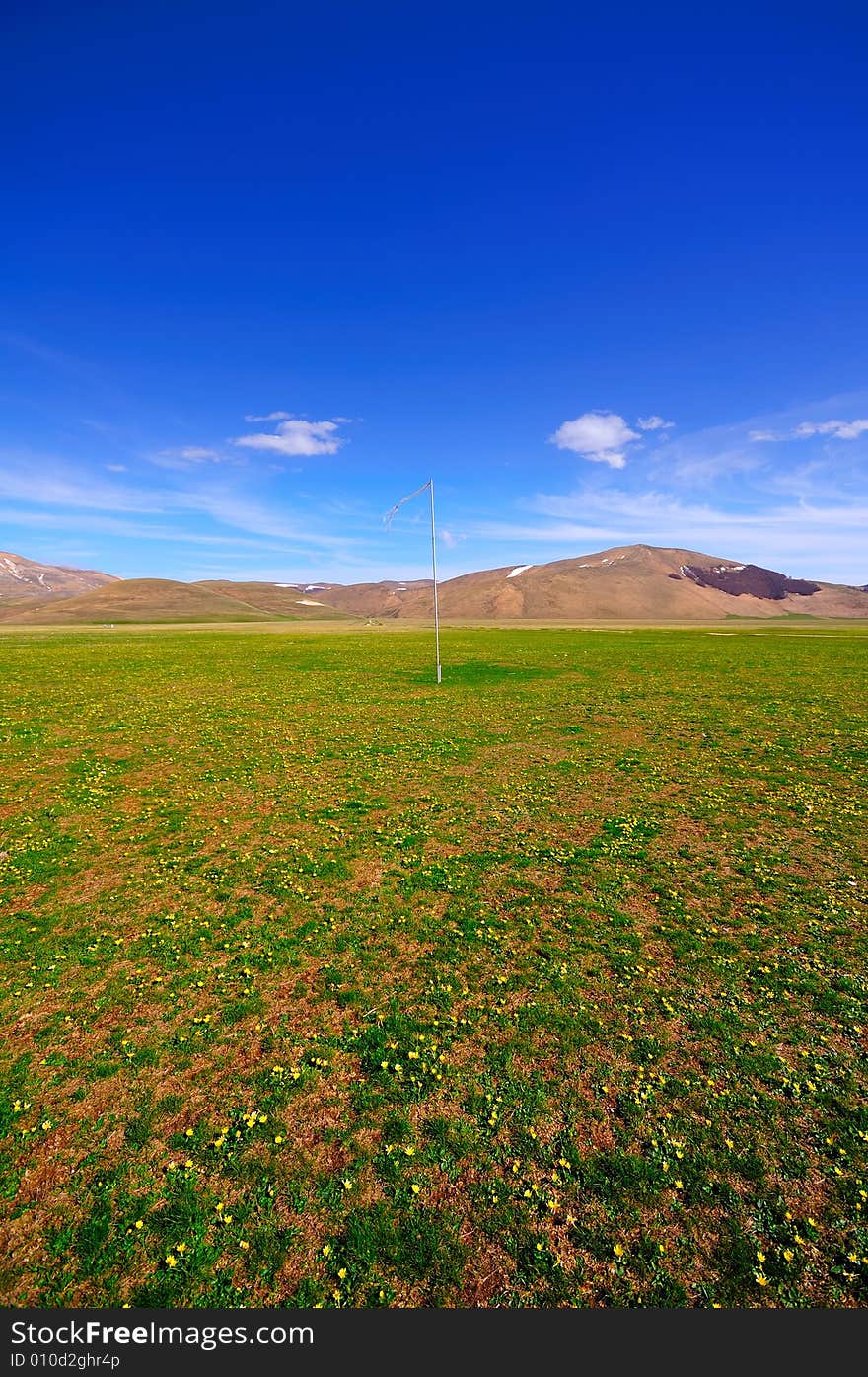 Plateau landscape with a flag