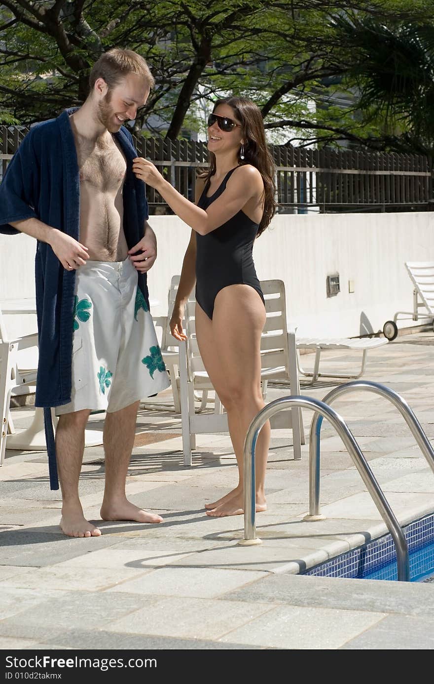 Couple Smiling Beside Pool - vertical