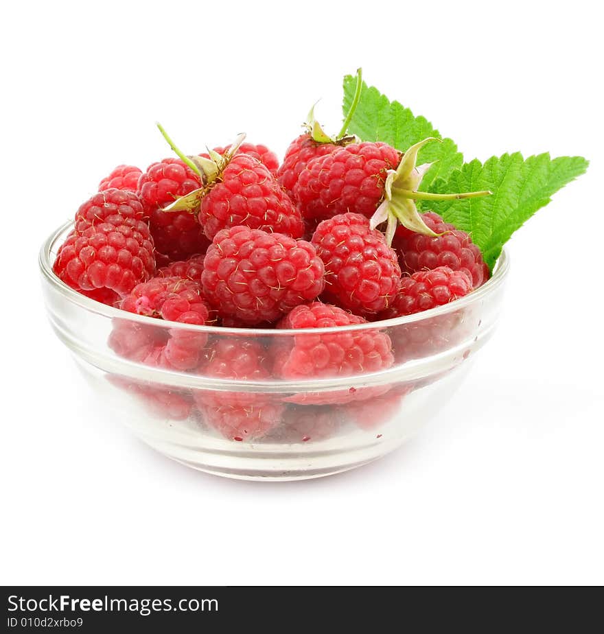 Red raspberry fruits in glass vase isolated on white background