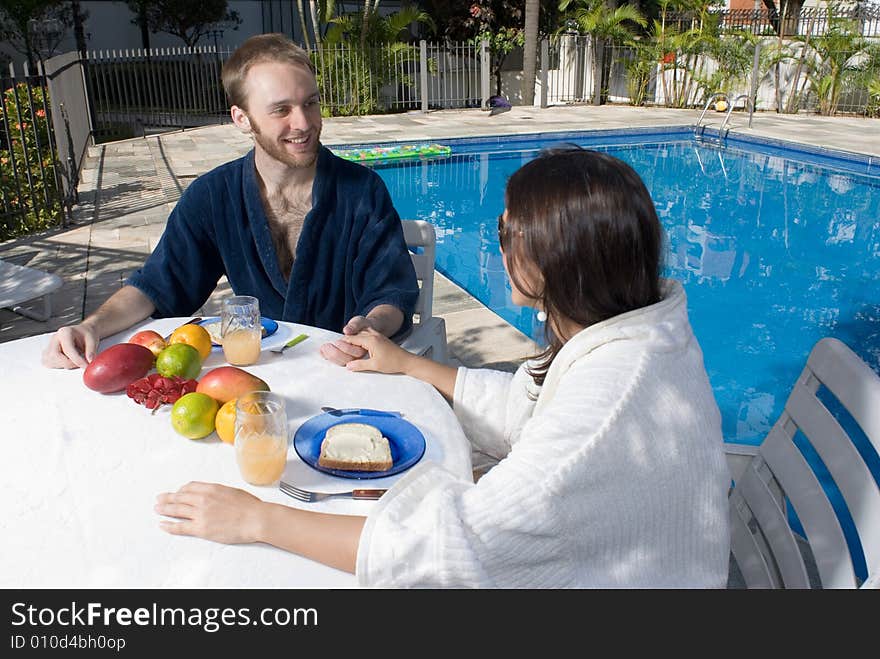 Couple Sitting At Table Holding Hands - Horizontal