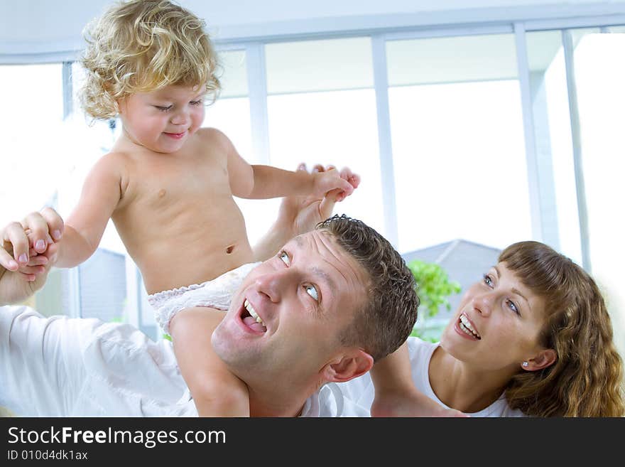 High key portrait of nice young family getting busy. High key portrait of nice young family getting busy