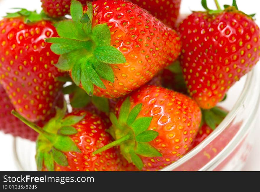 High key photo of fruit dish filled with nice red strawberries. High key photo of fruit dish filled with nice red strawberries