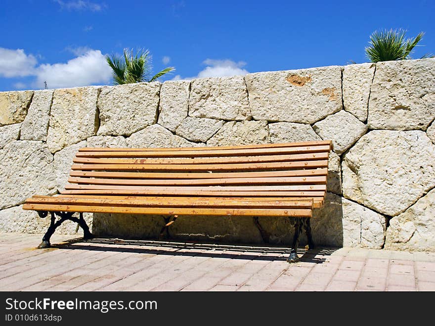 Slatted wooden seat to relax and watch world go by. Slatted wooden seat to relax and watch world go by