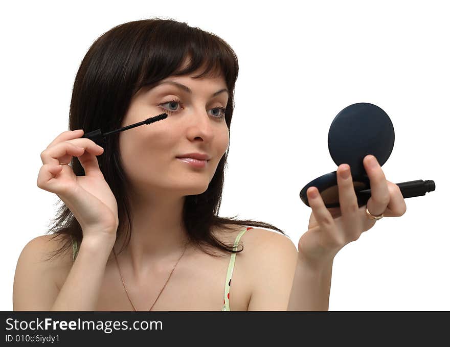 Young woman making up, isolated on white background