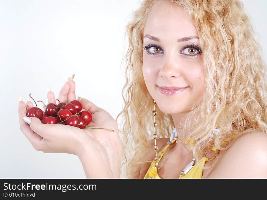 Beauty woman with red cherry in hands at white background