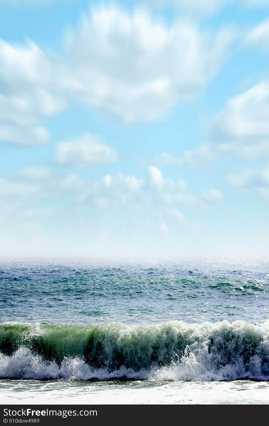 Wave on sea beach under year blue sky and cloud