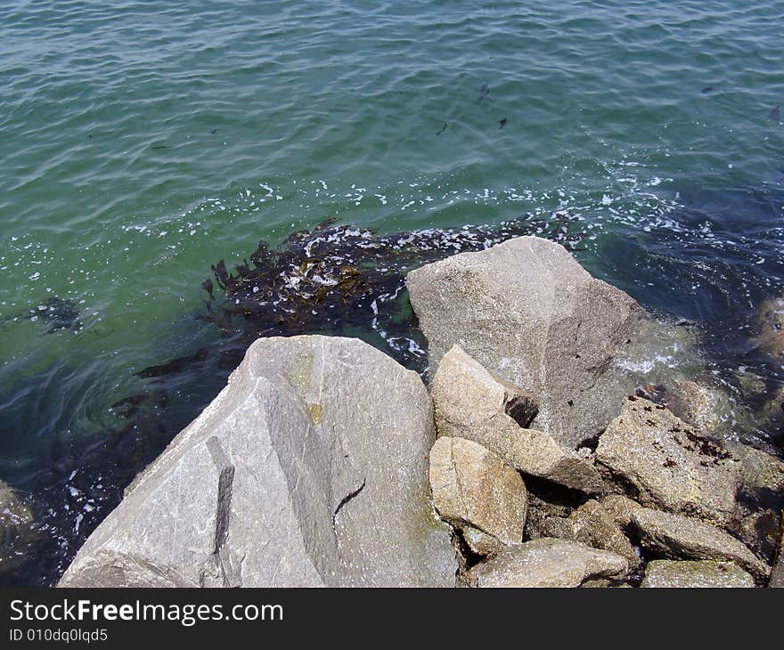 Blue ocean and boulders in the water