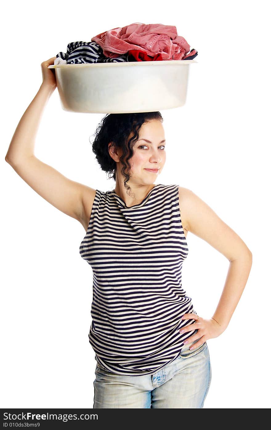 The beautiful girl holds a basin with clothes