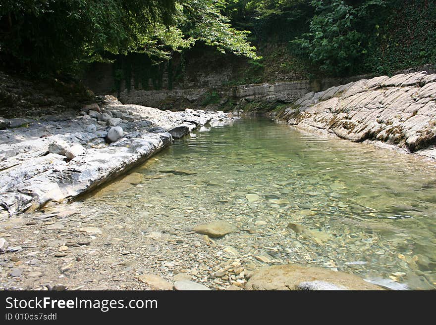 Mountain river on background year wood. Mountain river on background year wood