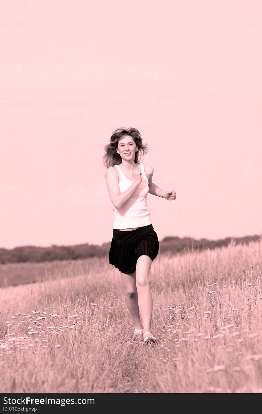 A beautiful girl running on the field