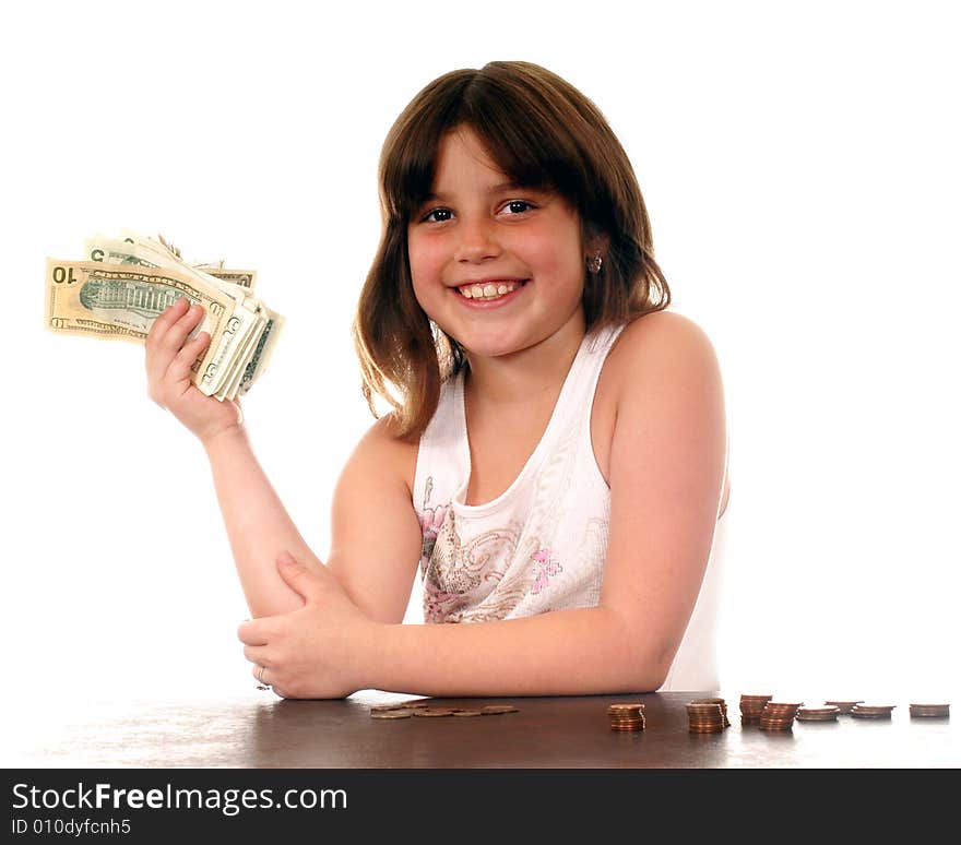 Elementary girl delighted with the fist full of dollars she's holding. Elementary girl delighted with the fist full of dollars she's holding.