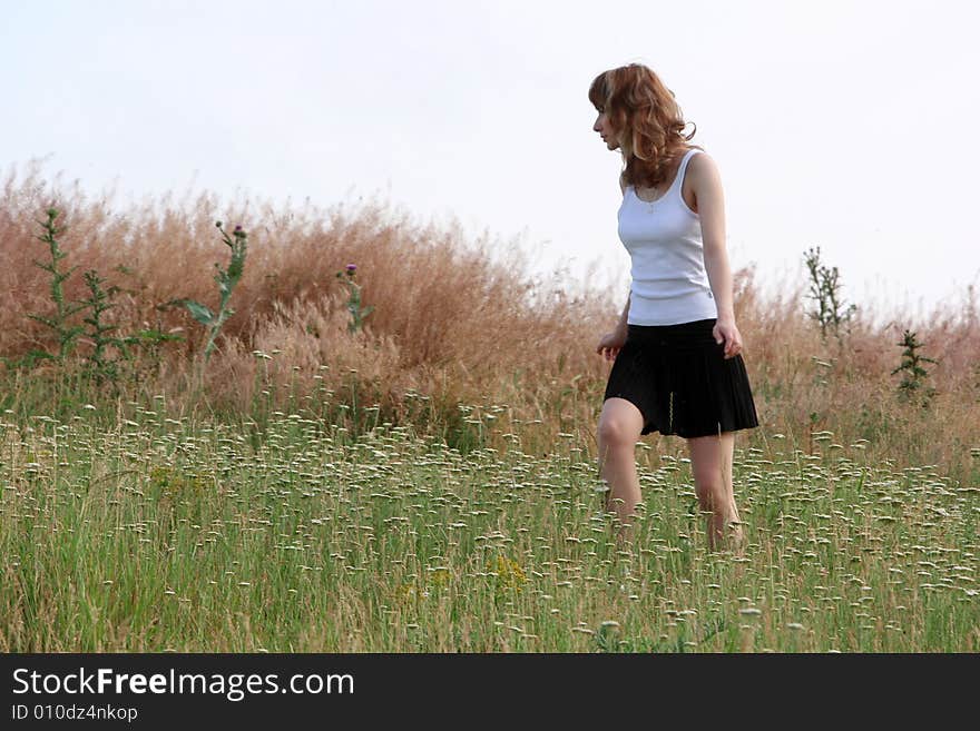 A beautiful girl walking on the field