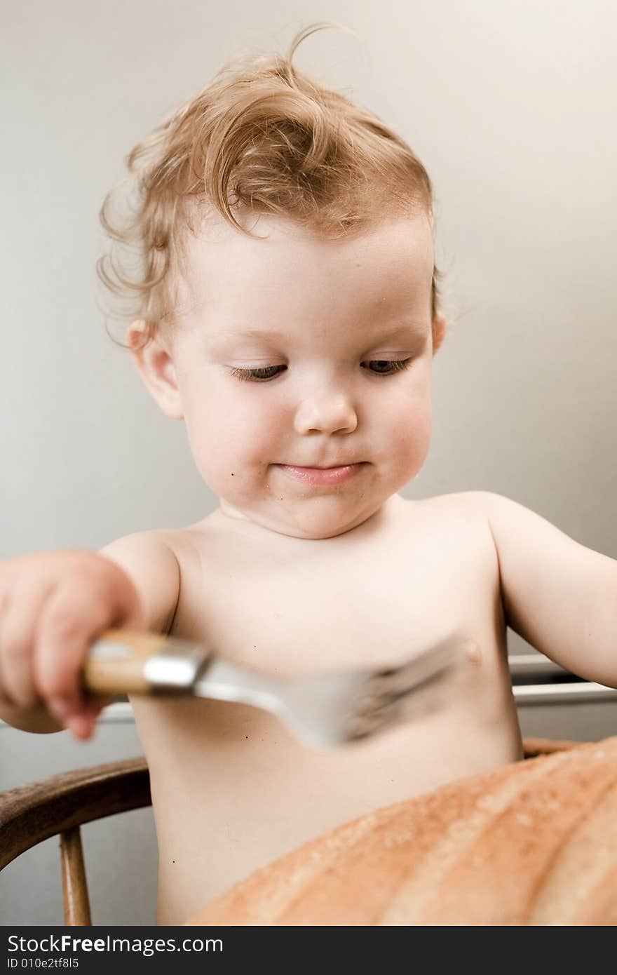 An image of baby eating white bread. An image of baby eating white bread