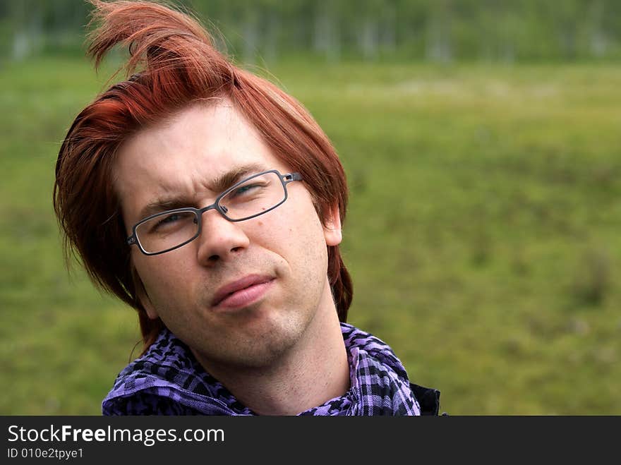 Young man with glasses looking sceptical