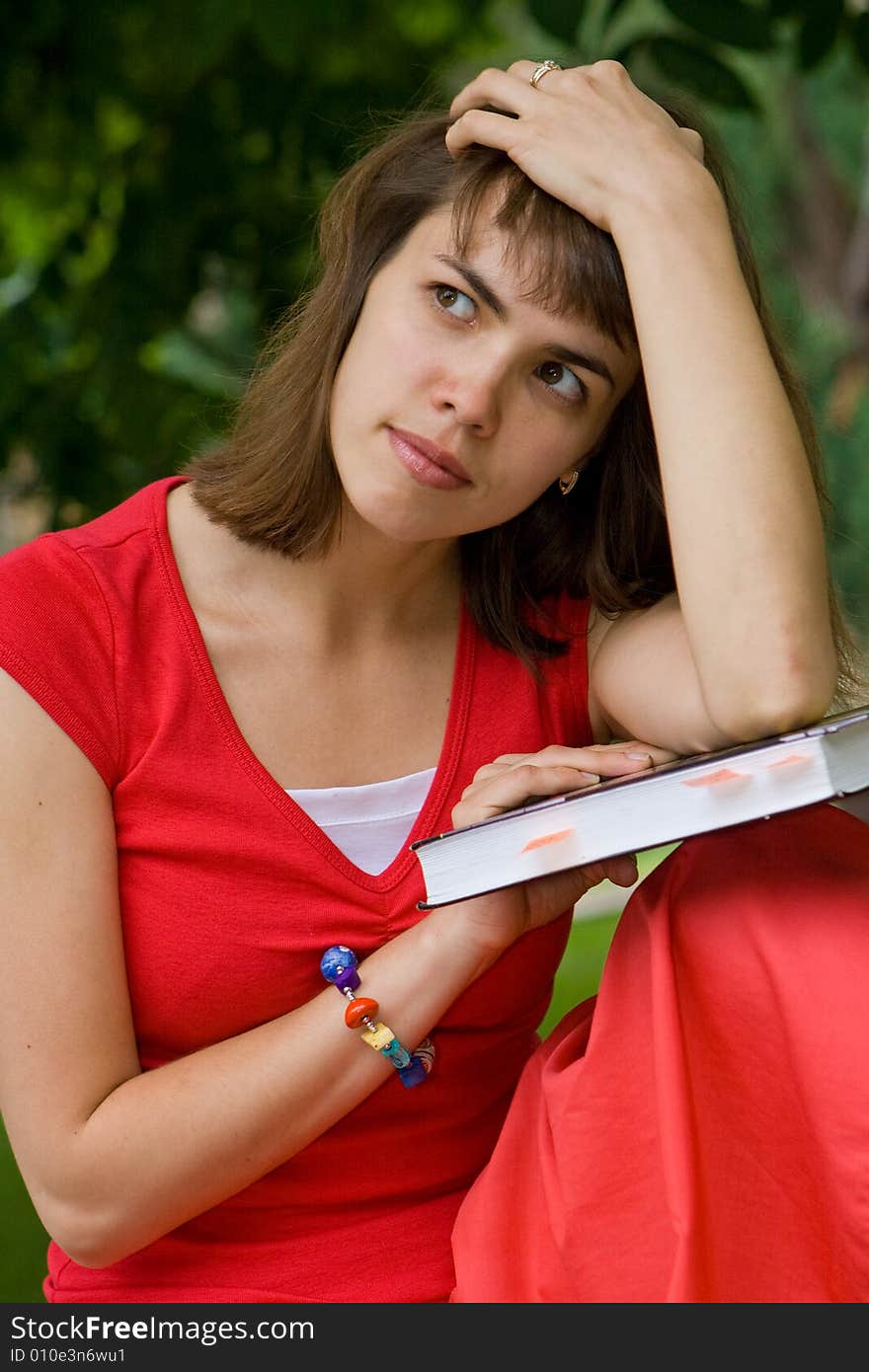 A beautiful young college girl thinking hard. A beautiful young college girl thinking hard