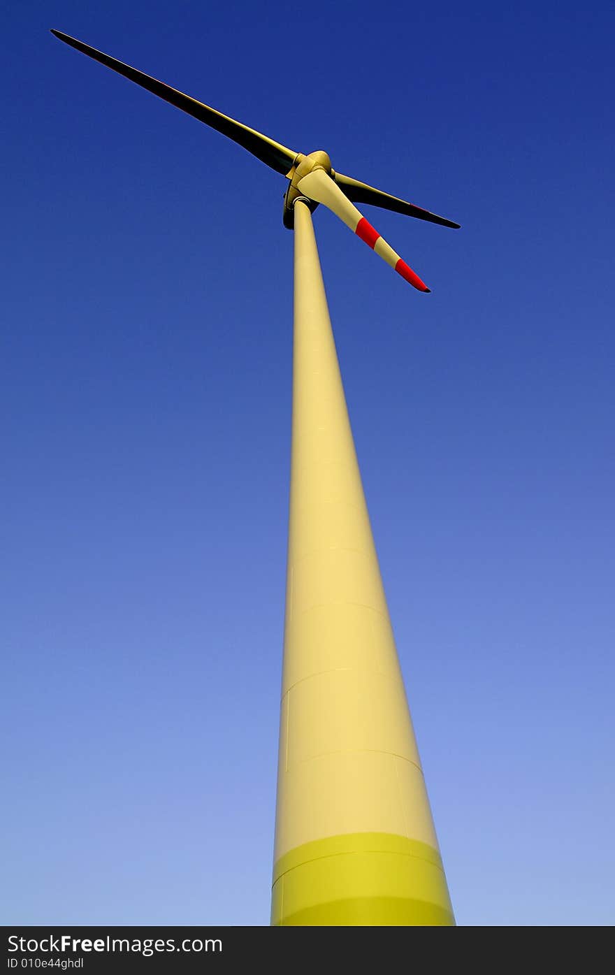 Windenergyplant in front a blue sky