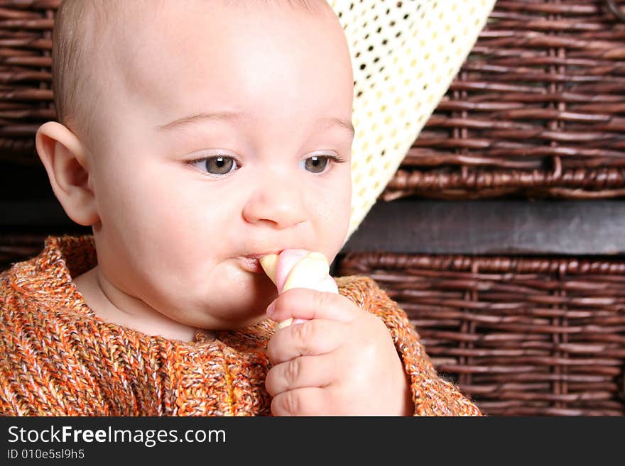 Six month old baby sitting infront of wooden drawers. Six month old baby sitting infront of wooden drawers