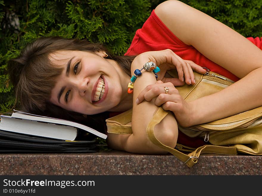 A beautiful young college girl resting on a marble plate. A beautiful young college girl resting on a marble plate