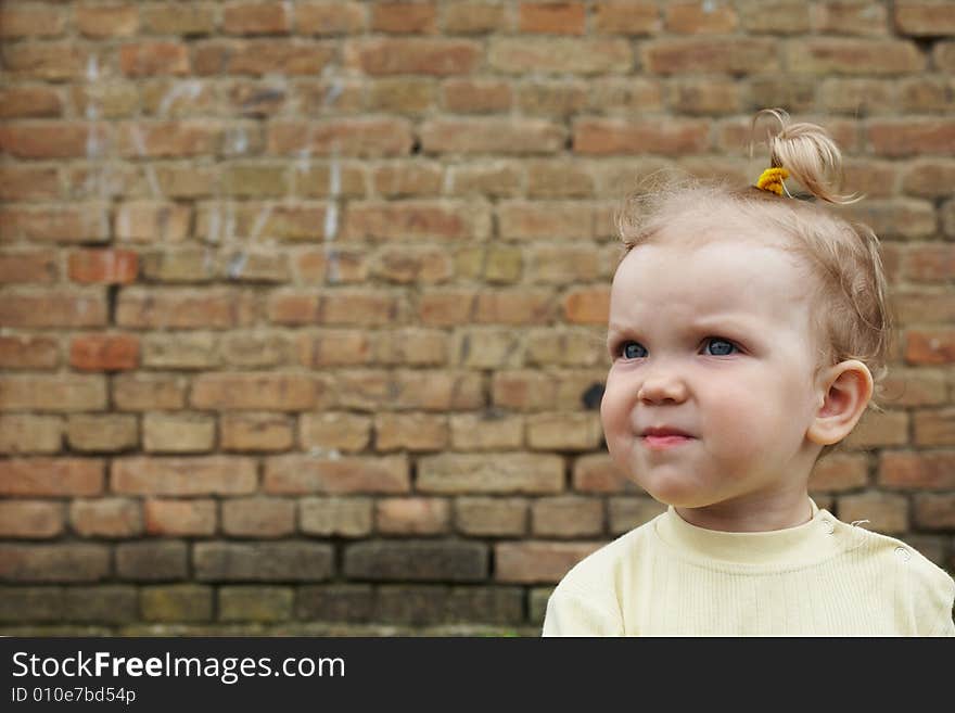 Girl near brick wall