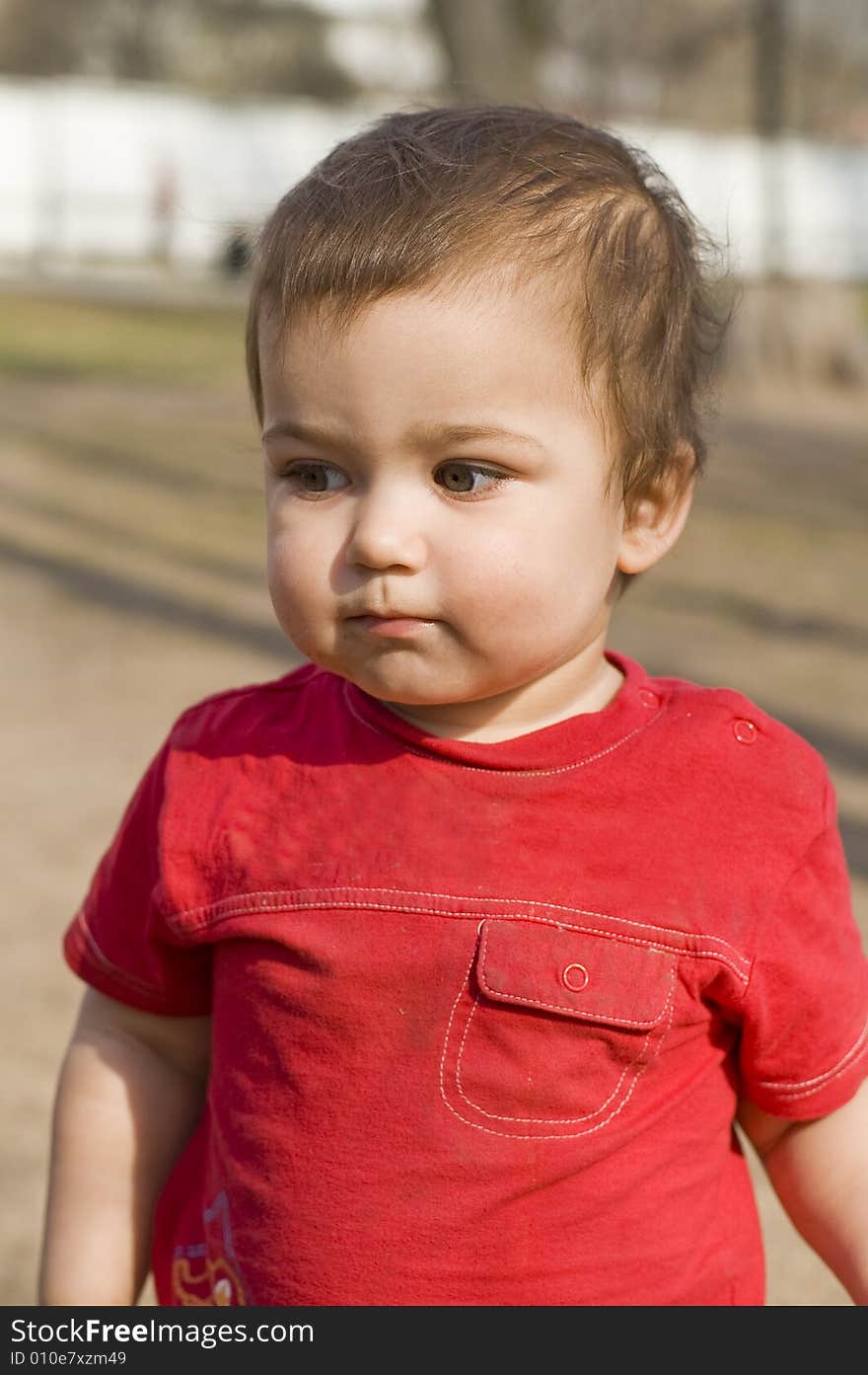 Crafty boy in red t-short outdoors