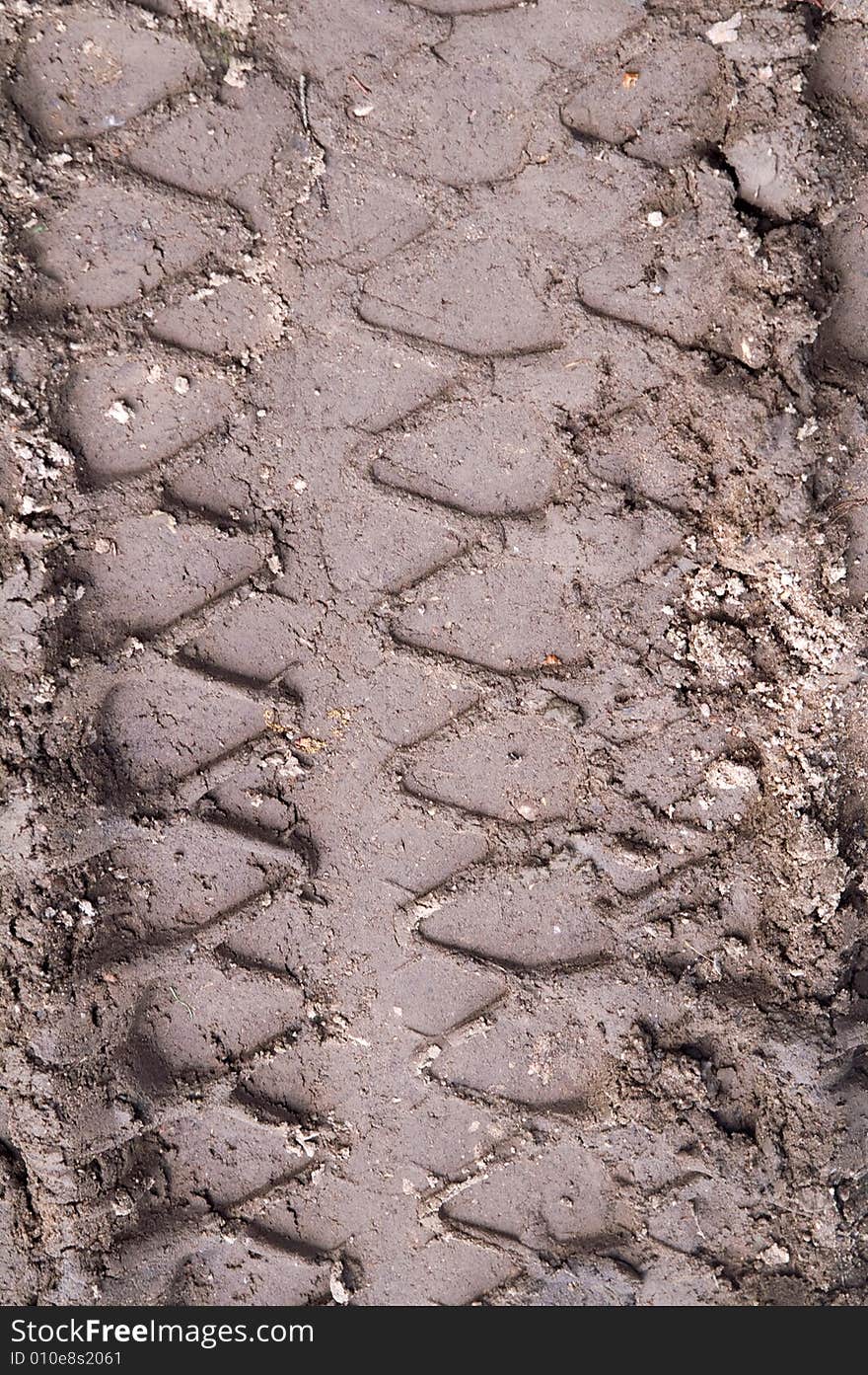 Wheel track in  brown mud. Wheel track in  brown mud