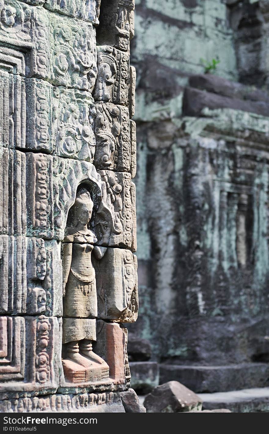 Temple Preah Khan besides ancient Angkor Thom. Detailed wall reliefs and overgrown green wall textures. Temple Preah Khan besides ancient Angkor Thom. Detailed wall reliefs and overgrown green wall textures.