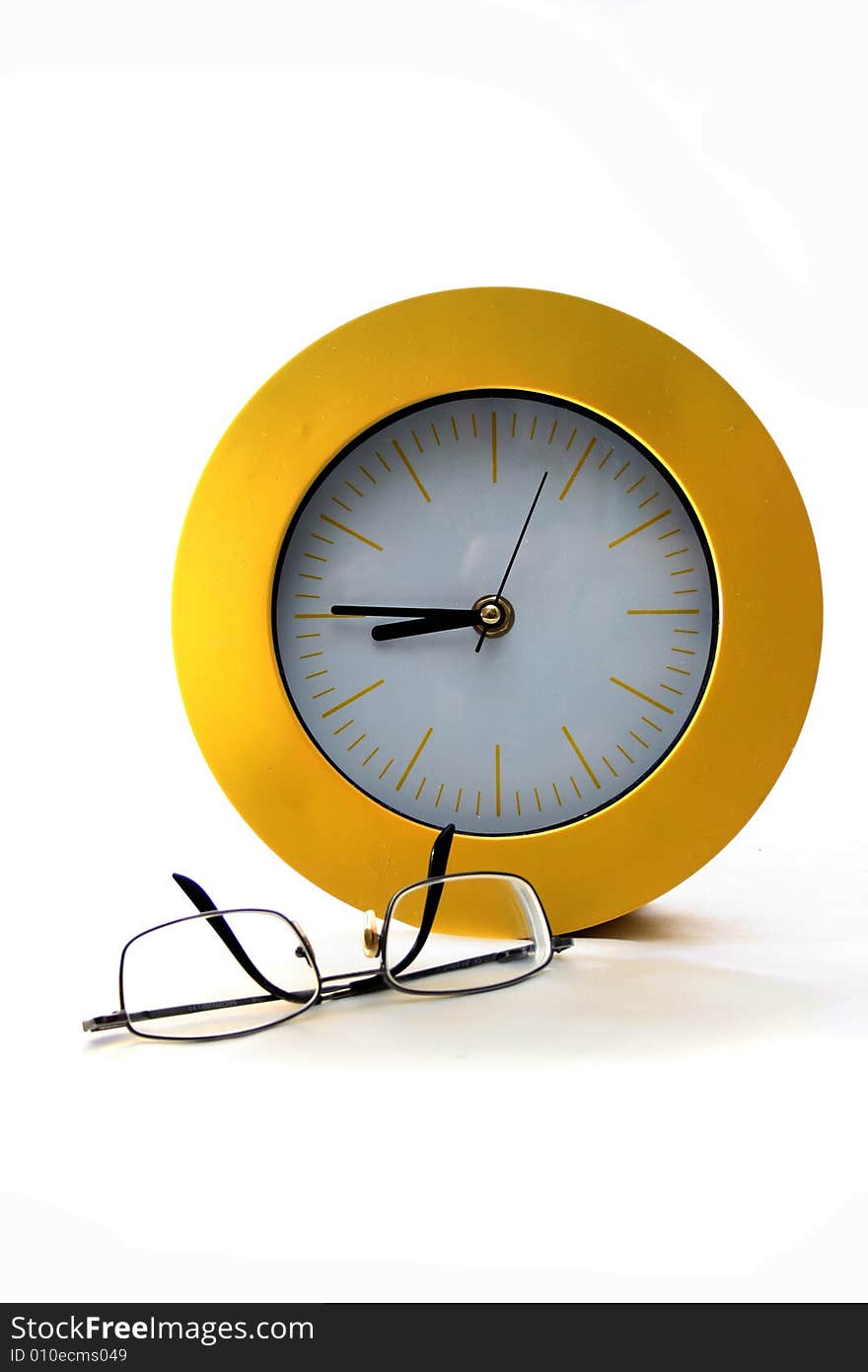 Yellow, round, analog clock with hands and unused glasses with black frameanalog clock day frame glasses hands hour isolated minute nine shades specs time white work workday yellow. Yellow, round, analog clock with hands and unused glasses with black frameanalog clock day frame glasses hands hour isolated minute nine shades specs time white work workday yellow