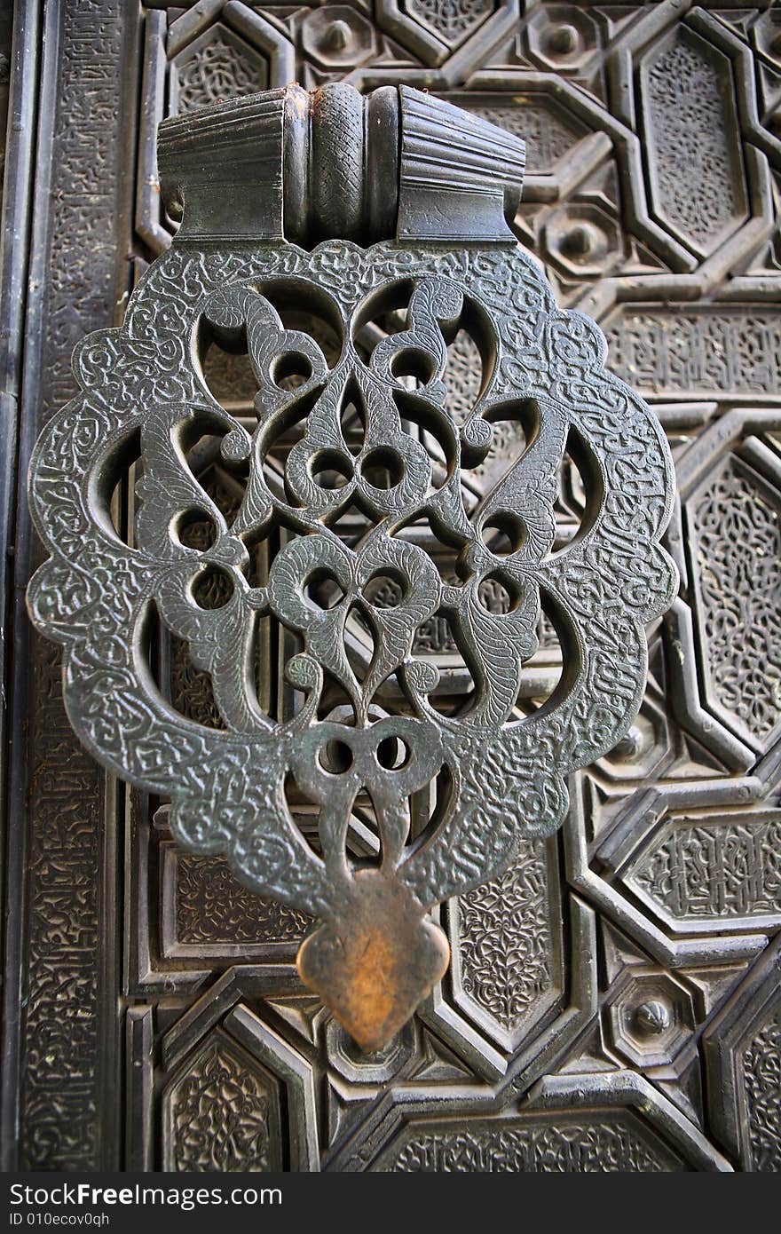 Door handle and ornament background (Cathedral in Seville, Spain)