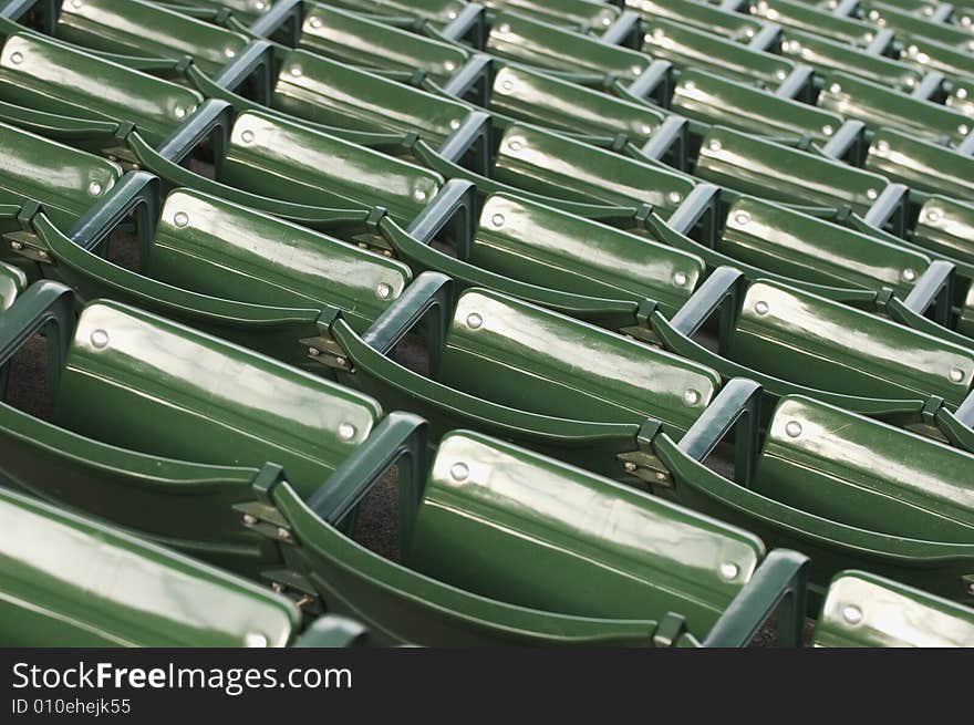 Empty green stadium seating at a baseball game. Empty green stadium seating at a baseball game