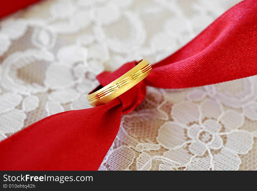 Beautiful gold wedding ring tie on a red ribbon