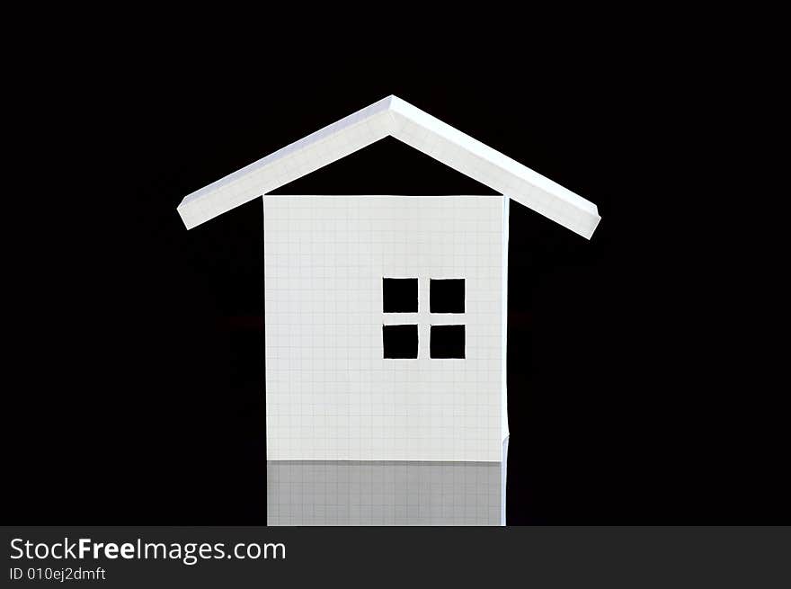 Paper house from the notebook sheet against the black background. Paper house from the notebook sheet against the black background