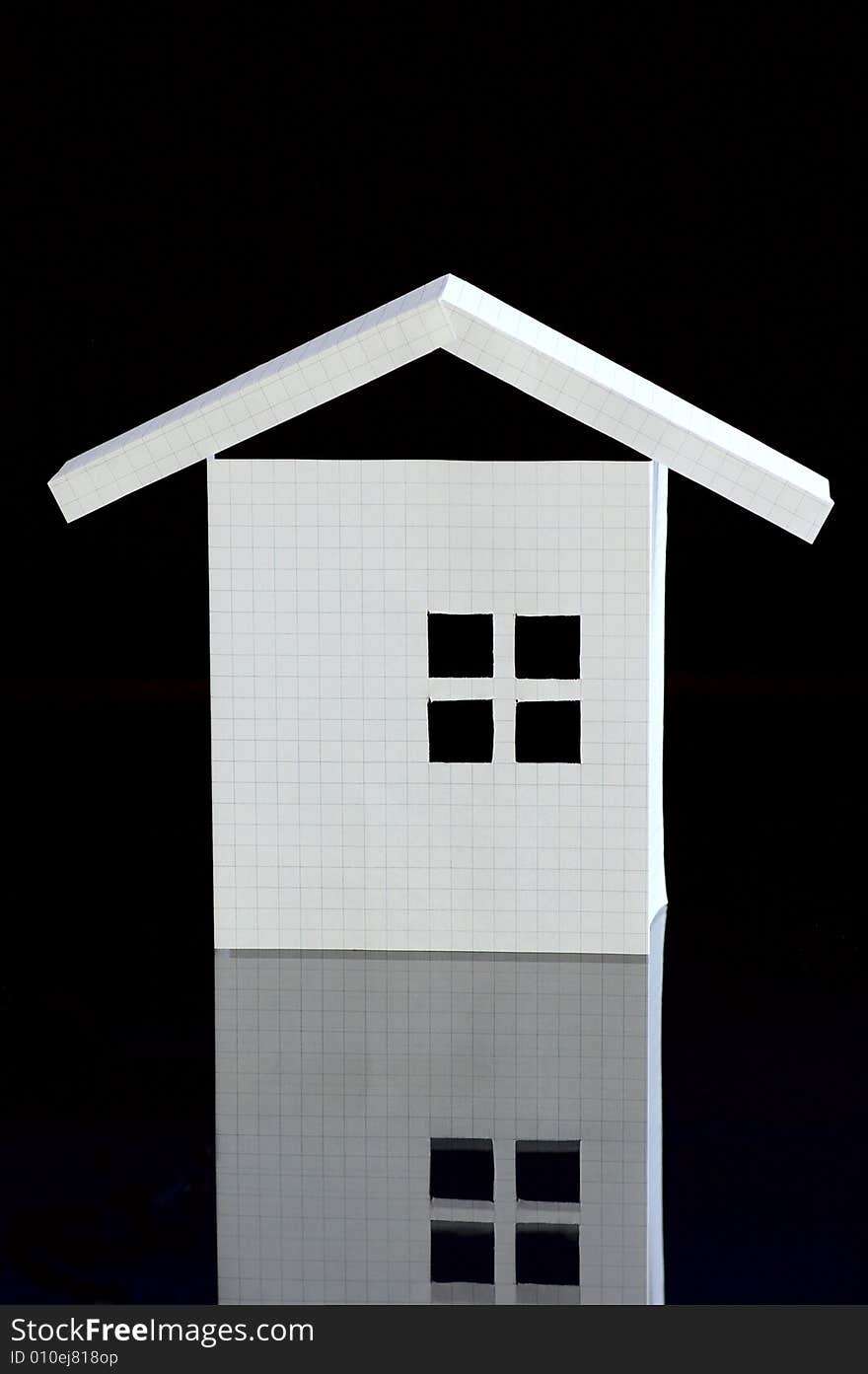 Paper house from the notebook sheet against the black background