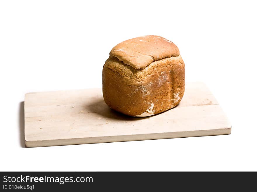 Loaf of homemade white bread on cutting board - isolated on white background