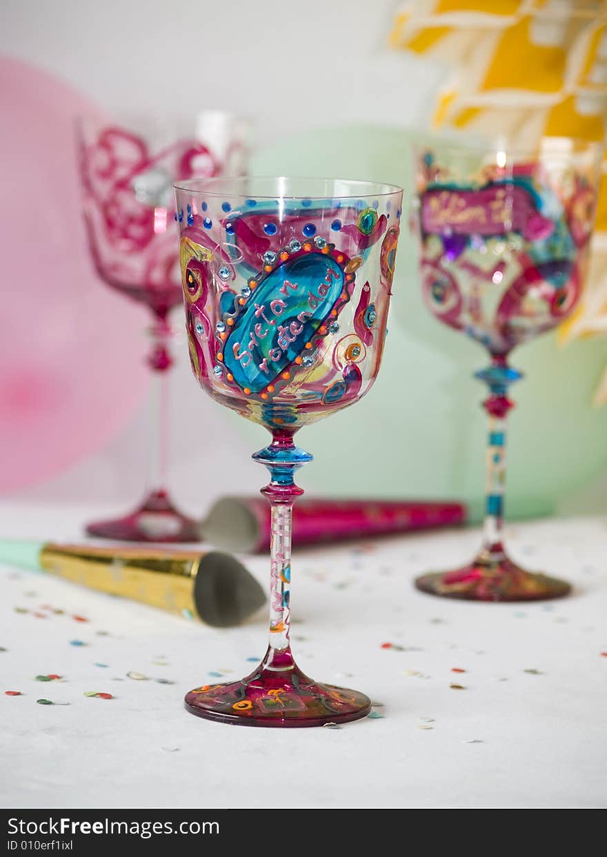 Colorful glasses, party decorations at background. Colorful glasses, party decorations at background