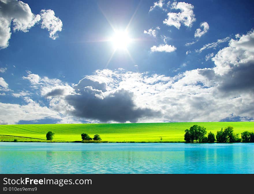 Field on a background of the blue sky. Field on a background of the blue sky