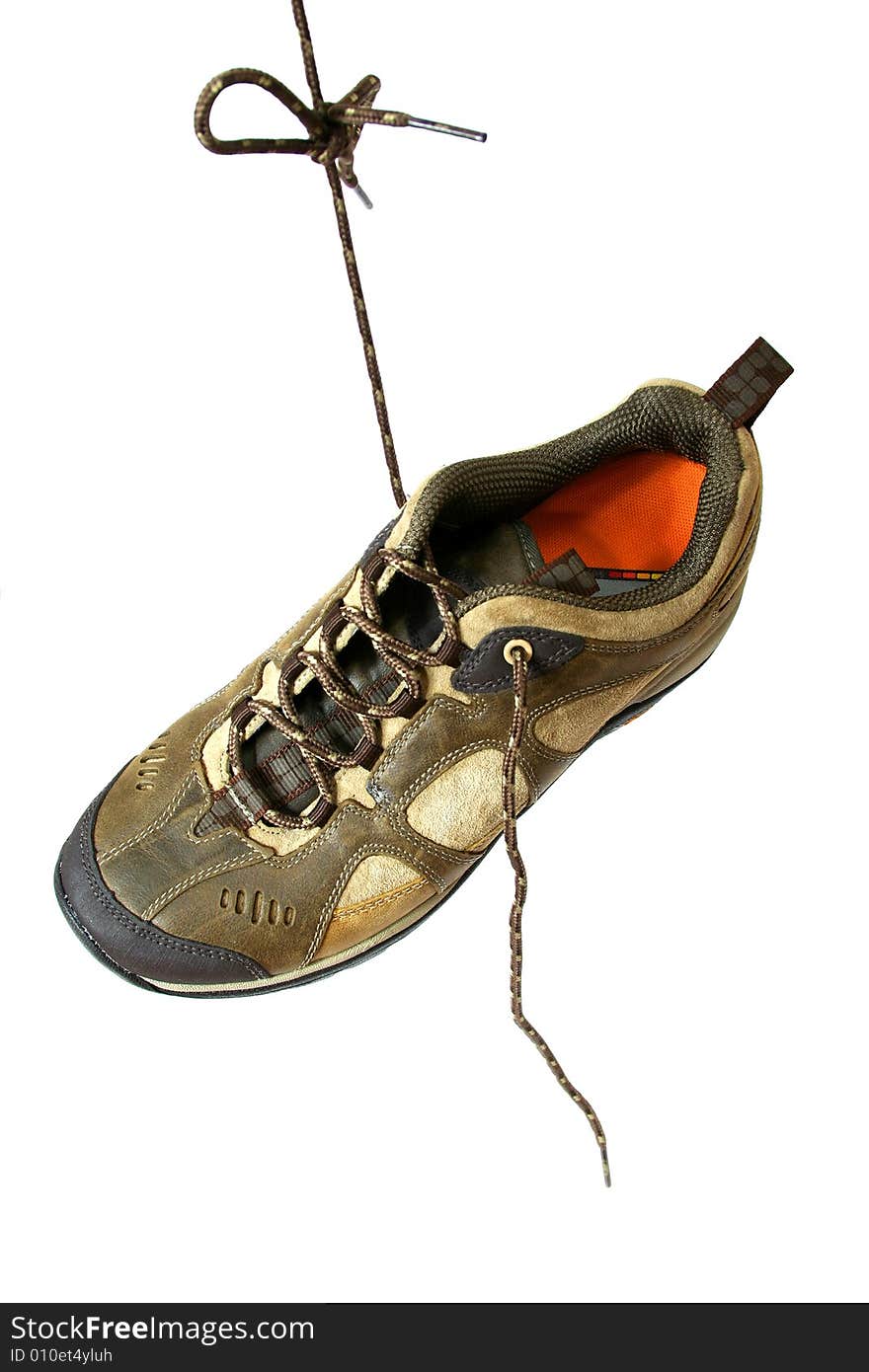 Hiking boots hangs on lace isolated on white background