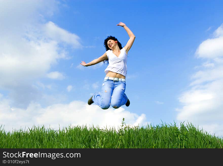 Happy young woman is jumping