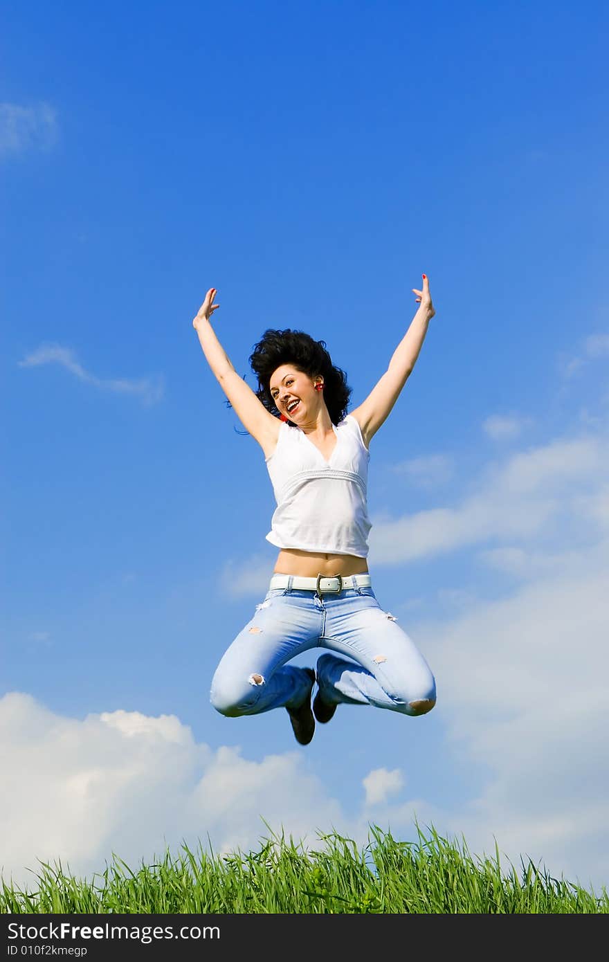 Happy young woman is jumping