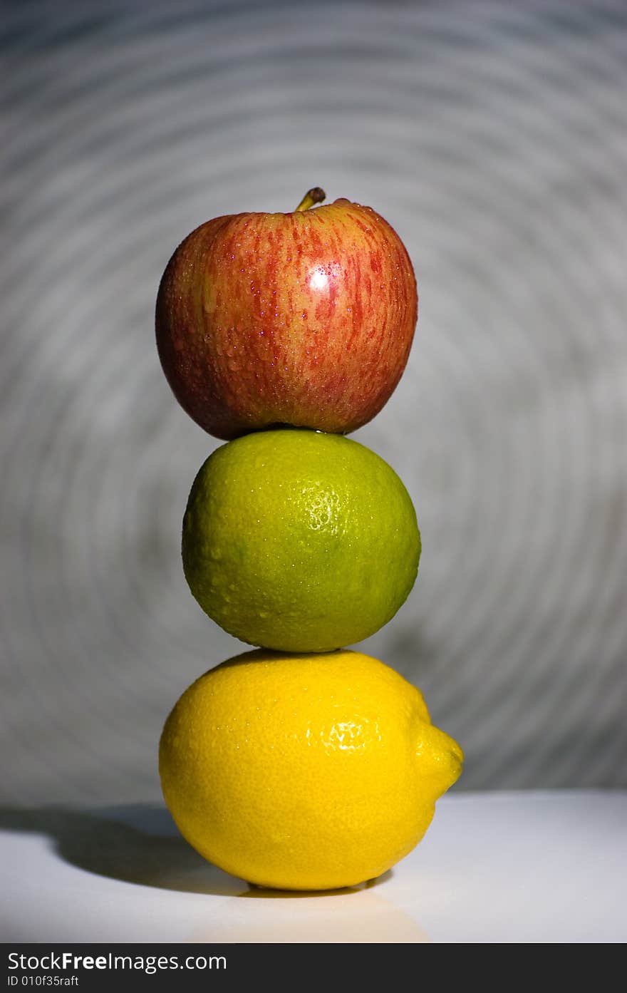 Pyramid from fruit. Apple, lemon and lime.